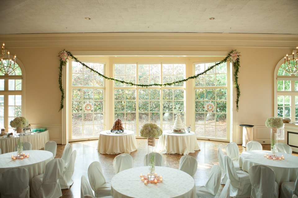 Over the bay window, a garland with floral bouquets was hung to frame the bride and groom's cakes. 